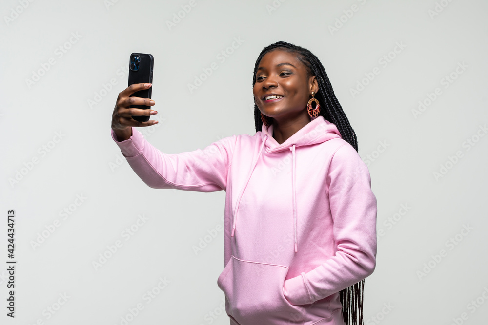 Young African American woman take selfie on the phone isolated on white background Young African American woman take selfie on the phone isolated on white background