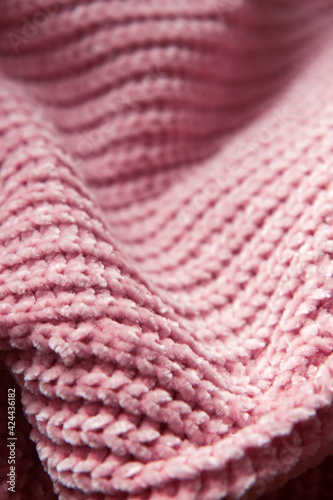 The beautiful texture of the knitted fabric. Knitted nude pink fabric as background. Copy space
