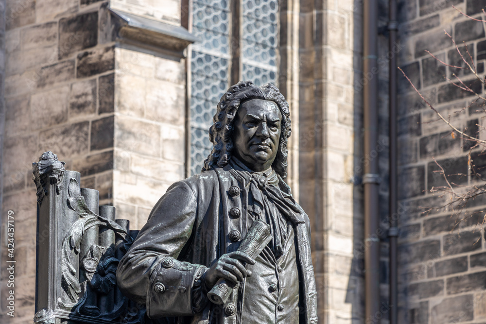 Leipzig, Saxony, Germany, 03-31-2021 Monument to the Thomaskantor and composer Johann Sebastian Bach in front of the Thomaskirche