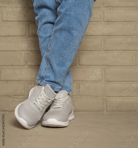 Women's sports comfortable shoes on the background of a brick wall.