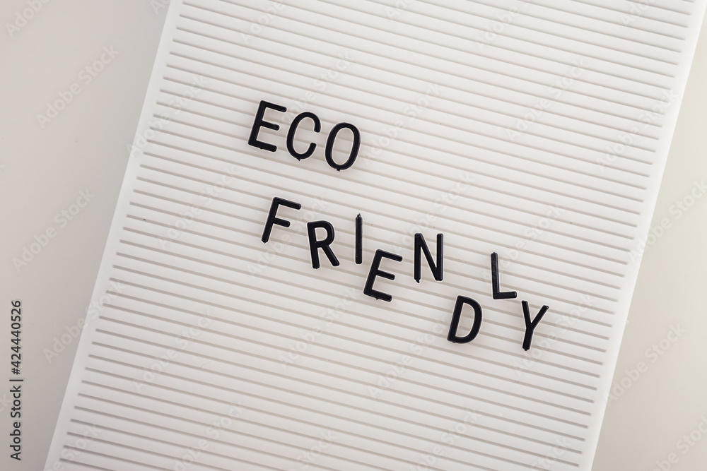 Zero waste concept, pros and cons. Black letters on a peg board with message text Eco friendly on white background. Flat lay.