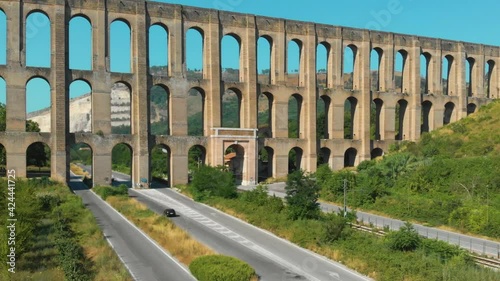 Aerial view. The Aqueduct of Vanvitelli, Caroline. Valle di Maddaloni, near Caserta Italy. 17th century. Large stone structure for transporting water. Viaduct. Road, freeway with vehicle traffic. photo