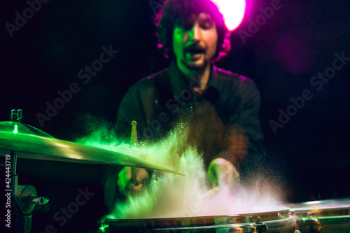 Drummer's rehearsing on drums before rock concert. Man recording music on drumset in studio