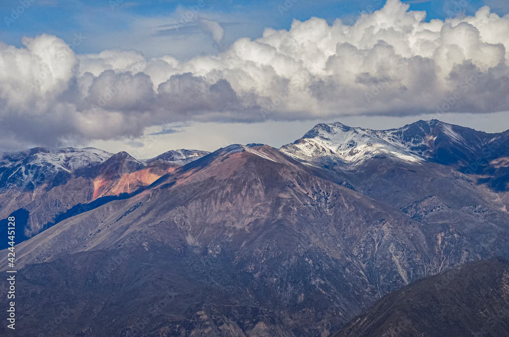 Aerial view of mountains and clouds in Colca Canyon region in Peru. Southamerican valley landscape