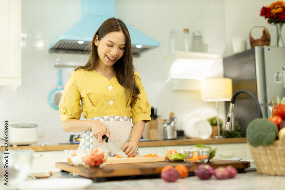 Woman cooking rice with vegetables in kitchen