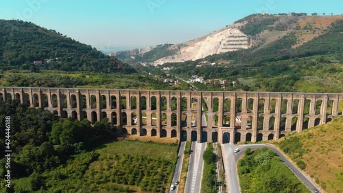 Aerial view. The Aqueduct of Vanvitelli, Caroline. Valle di Maddaloni, near Caserta Italy. 17th century. Large stone structure for transporting water. Viaduct. Road, freeway with vehicle traffic. photo