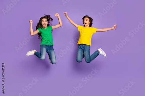 Full body photo of children jump up winner wear casual clothes positive mood isolated on violet color background