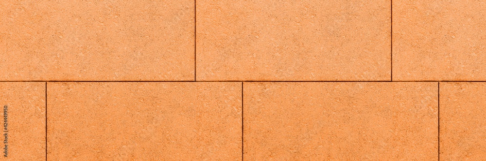 Fototapeta premium Panorama of Building exterior brown granite block wall texture and background seamless