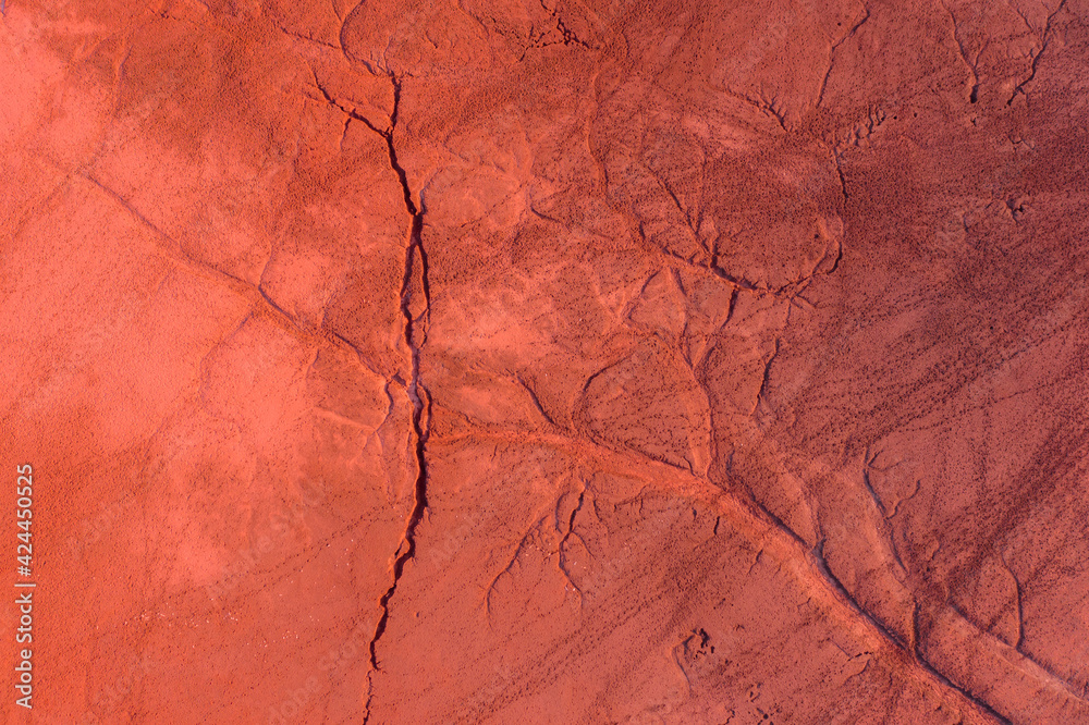 Fototapeta premium Neszmély, Hungary - Aerial view of drought red mud surface, industry waste, abstract nature texture.