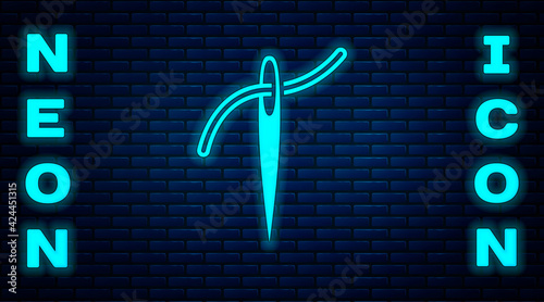 Glowing neon Needle for sewing with thread icon isolated on brick wall background. Tailor symbol. Textile sew up craft sign. Embroidery tool. Vector