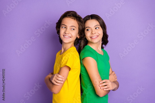 Photo of two brunette happy brother and sister stand back to back arms crossed isolated on violet color background