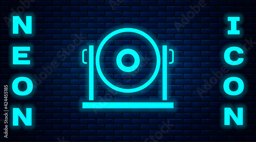 Glowing neon Gong musical percussion instrument circular metal disc icon isolated on brick wall background. Vector