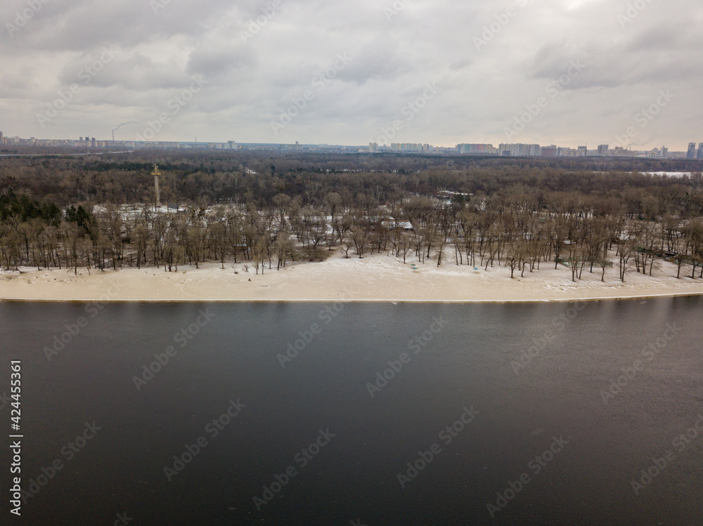 Light snow on the sandy bank of the river. Aerial drone view.