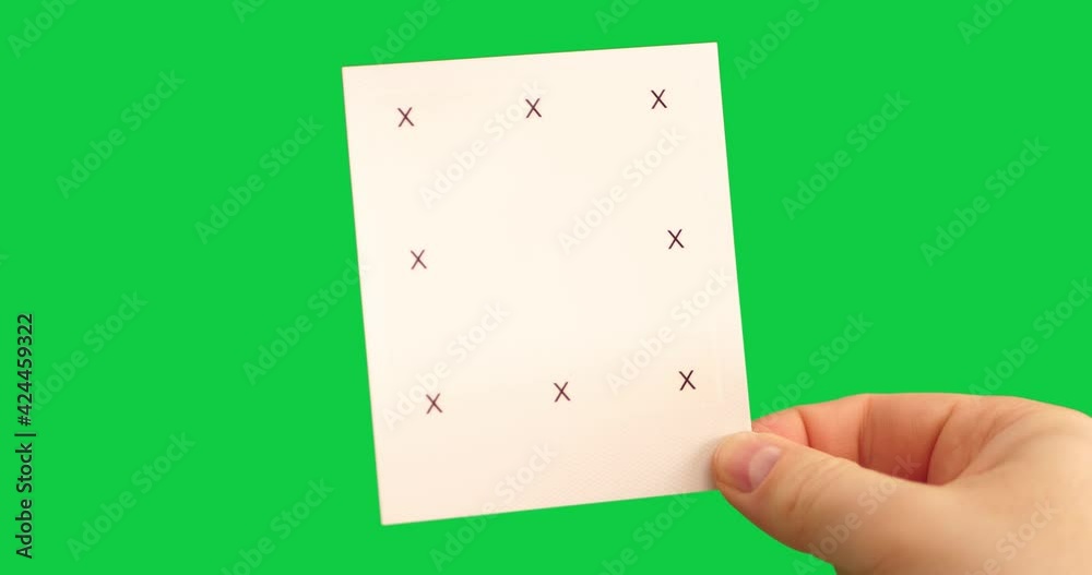 Instant photo with markers in male hand on green background as a template for motion tracking