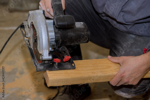 Circular saw carpenter using for wood beam © ungvar