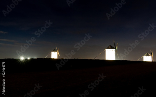 traditional whitewshed Spanish windmills in La Mancha just after sunset under a cool blue night sky photo