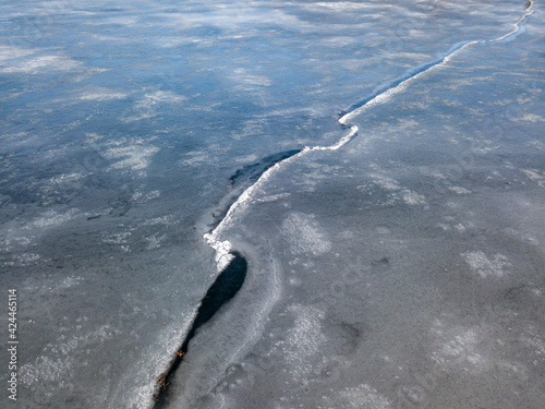 Crack of ice on the river. Aerial drone view.