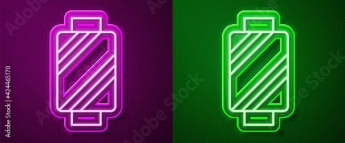 Glowing neon line Sewing thread on spool icon isolated on purple and green background. Yarn spool. Thread bobbin. Vector