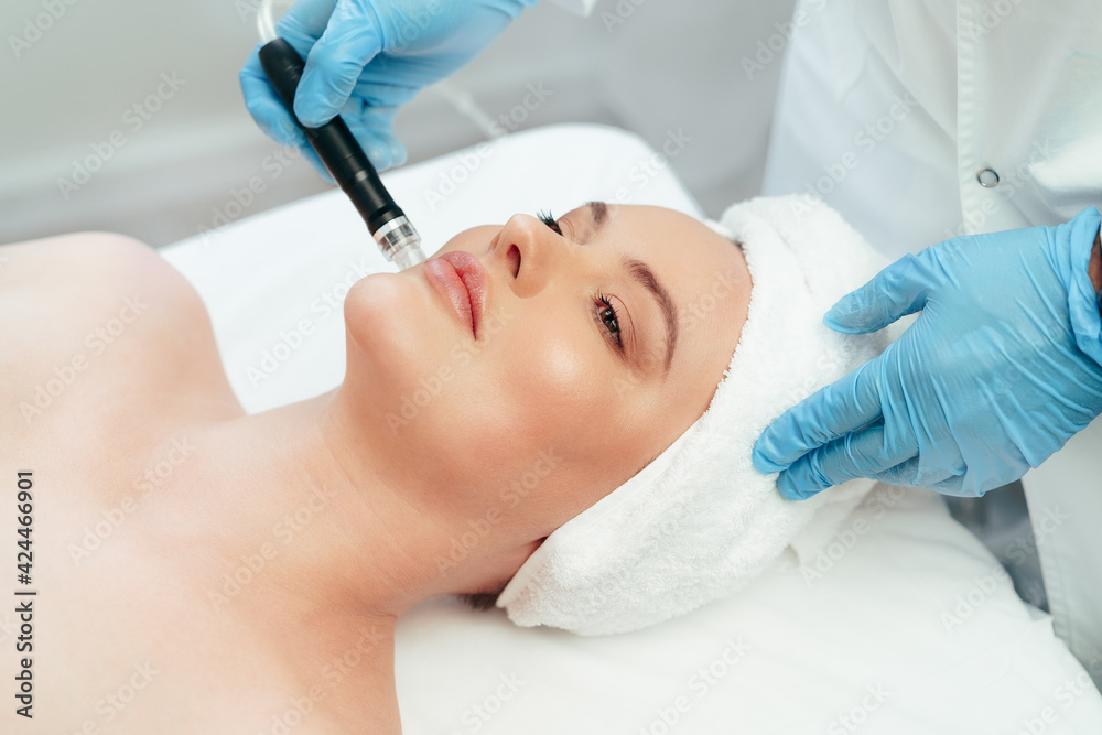 Beautiful woman getting facial skincare treatment in a cosmetic beauty clinic Beautiful woman getting facial skincare treatment in a cosmetic beauty clinic