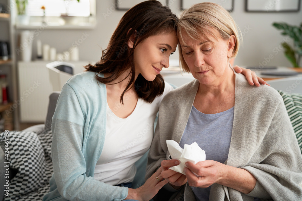 Woman comforting upset senior woman Woman comforting upset senior woman