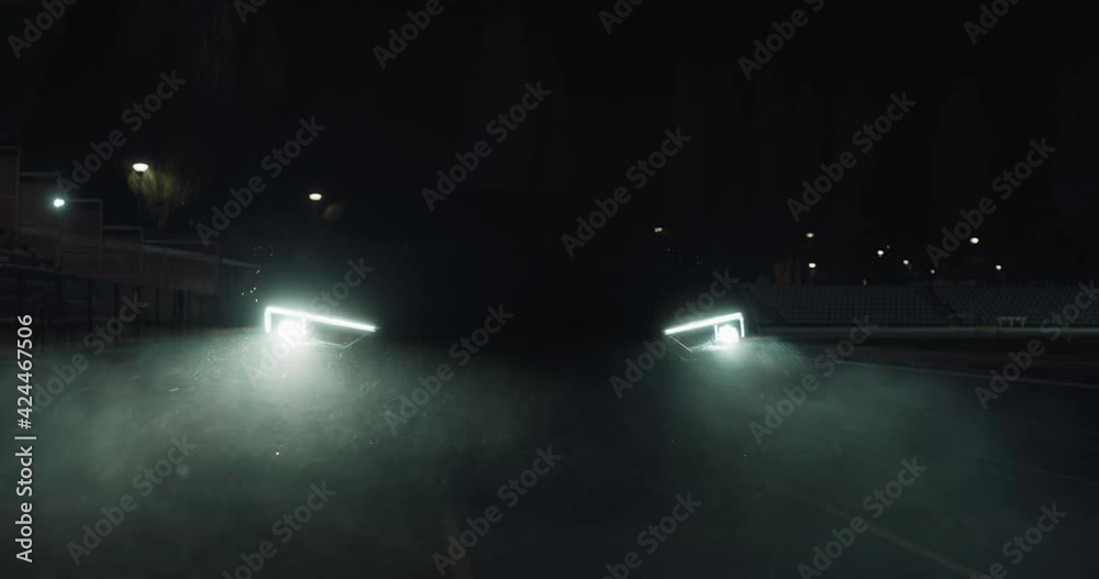 Cinematic close up shot of modern racing car with switched on ...