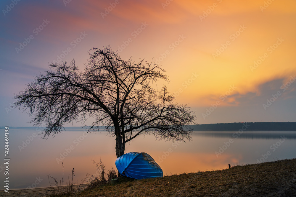 beautiful, fabulous sunrise over the Zemborzycki Reservoir in Lublin, boats lying on the shore
