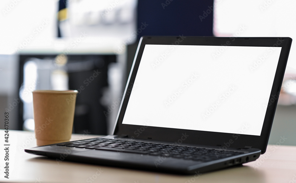 Cropped shot of Laptop blank screen with take away coffee on the table in office. Cropped shot of Laptop blank screen with take away coffee on the table in office.