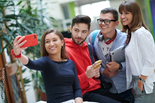 Group of multiethnic teenagers taking a selfie in school