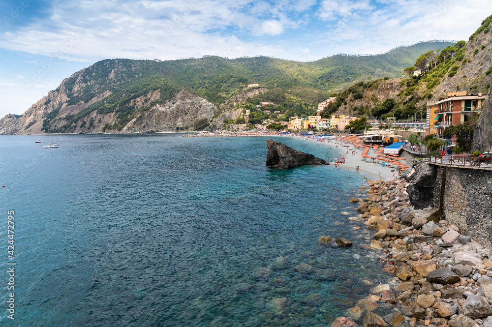 Monterosso, Liguria, Italy. June 2020. The promenade offers a pleasant view of the beaches with the bathing establishments and the surrounding nature. Beautiful summer day