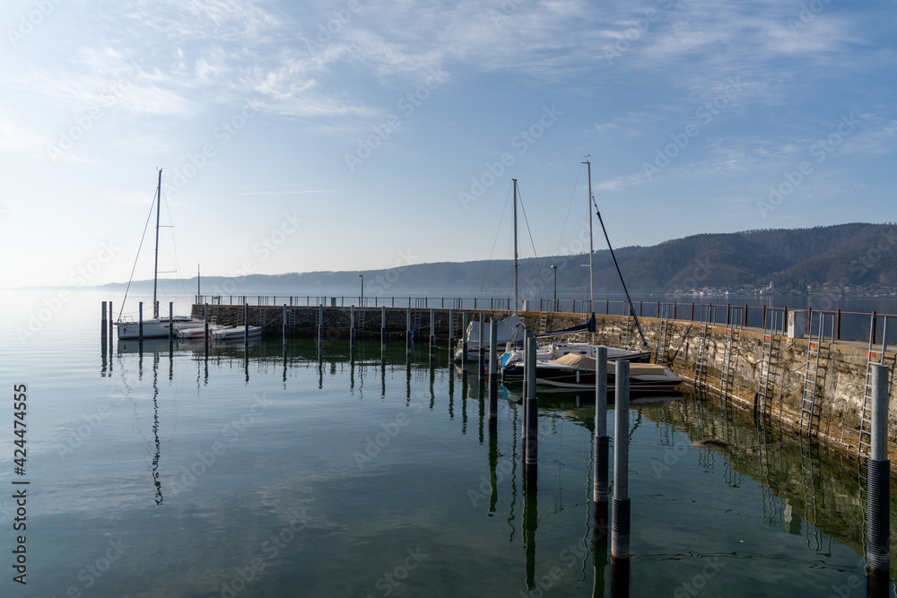 motorboats and sailboats in the old marina and harbor at Ludwigshafen on Lake Constance