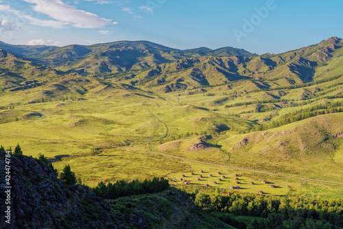 View of the national village in Kazanovka Khakassia steppe and mounyains sun