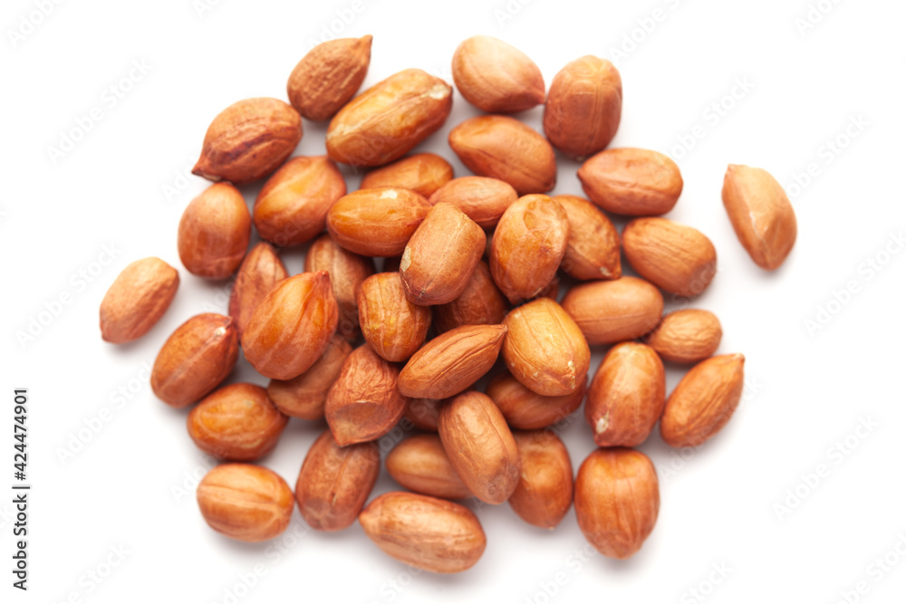 Macro Close-up of organic red-brown peanuts (Arachis hypogaea) cleaned on a white background. Top view Macro Close-up of organic red-brown peanuts (Arachis hypogaea) cleaned on a white background. Top view