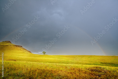 Thunderstorm with clouds and rain and rainbow Tarpig Khakassia park with sun
