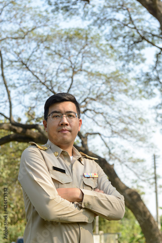 Thai Government Officer, Civil Servant wears Brownish-Yellow uniform.