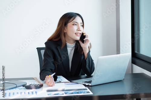 Portrait of Asian young business female working on laptop at home office