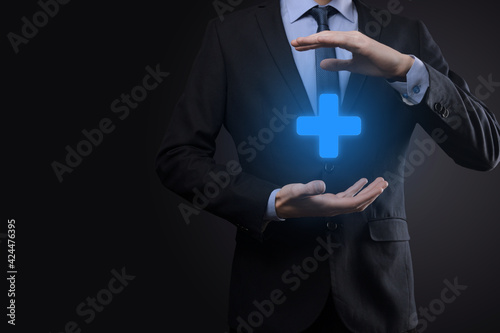 Fototapeta Naklejka Na Ścianę i Meble -  Businessman, man hold in hand offer positive thing such as profit, benefits, development, CSR represented by plus sign.The hand shows the plus sign