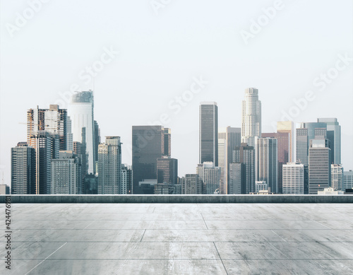 Empty dirty concrete rooftop on background of a beautiful Los Angeles skyline at sunset, mock up
