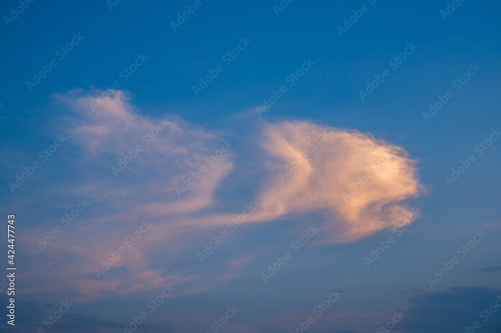 Strange clouds in the summer sky.The shape or pattern of natural white clouds looks strange and interesting.