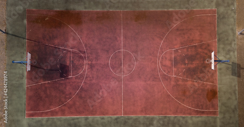 An old, poorly maintained, empty basketball court. Team sport.Aerial view of a drone sports field. Basket, game, no one is there.