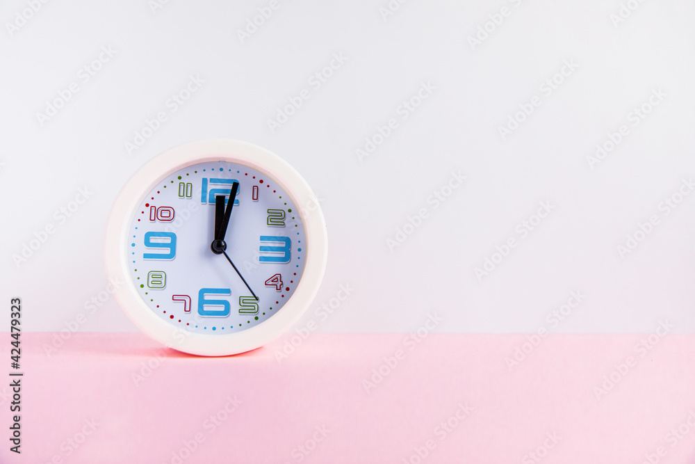 white table clock on light blank background white table clock on light blank background