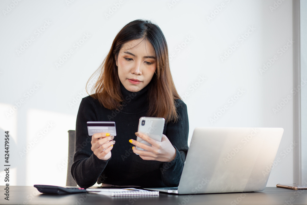 Portrait of Young woman using credit card and smartphone for buying online shopping at home ,payment,buying and online shopping concept. Portrait of Young woman using credit card and smartphone for buying online shopping at home ,payment,buying and online shopping concept.