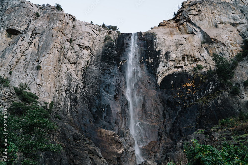 Tall waterfall on huge mountain cliff
