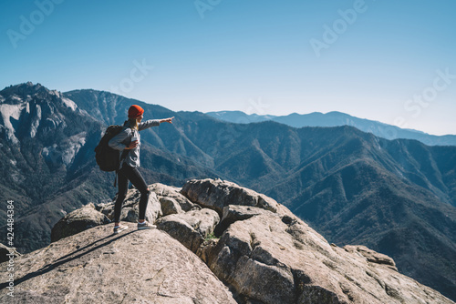 Young backpacker standing on mountain peak