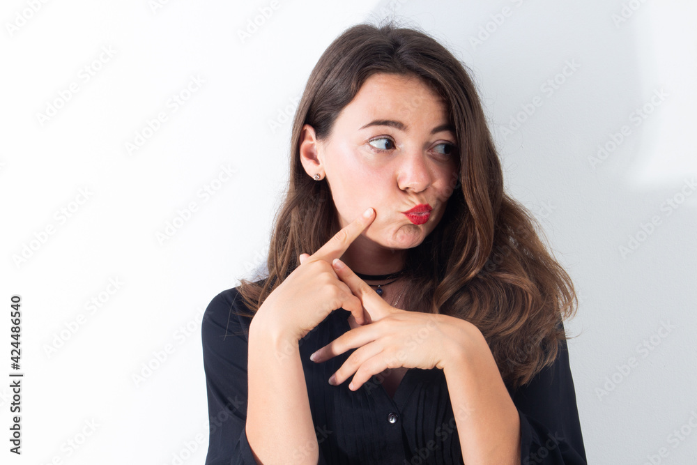 Attractive girl with lipstick posing isolated on white background. She has perfect skin Attractive girl with lipstick posing isolated on white background. She has perfect skin