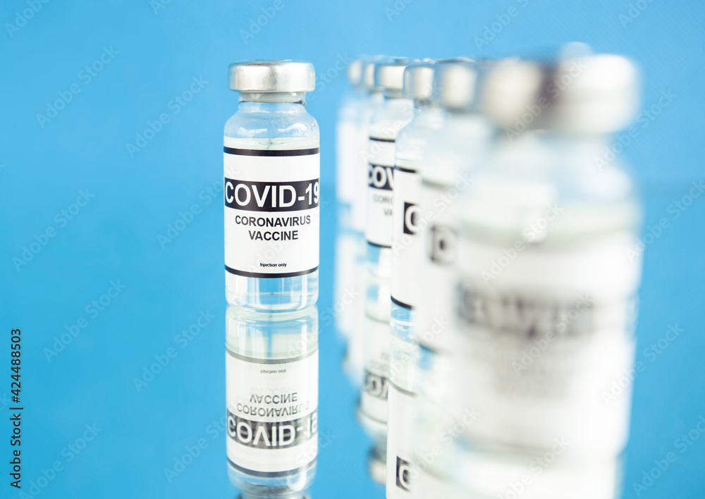 Covid-19 coronavirus vaccine on the blue background Covid-19 coronavirus vaccine on the blue background
