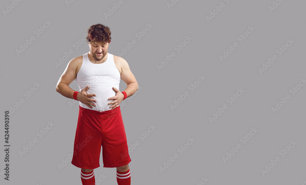 Slightly overweight man needs some gym training. Funny a bit chubby guy in  white tank top