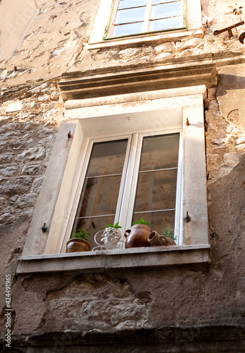 Beautiful ancient wall with window in old city of Kotor, Montenegro