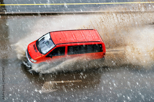 Snow storm in spring and cars