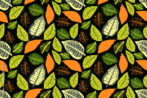 Vector floral seamless pattern with colorful leaves. Green, orange color leaves isolated on a dark background.