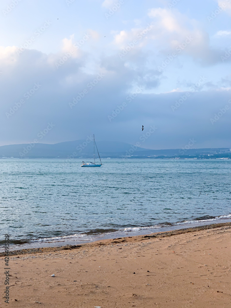 Fototapeta premium Beach view and sail in the distance